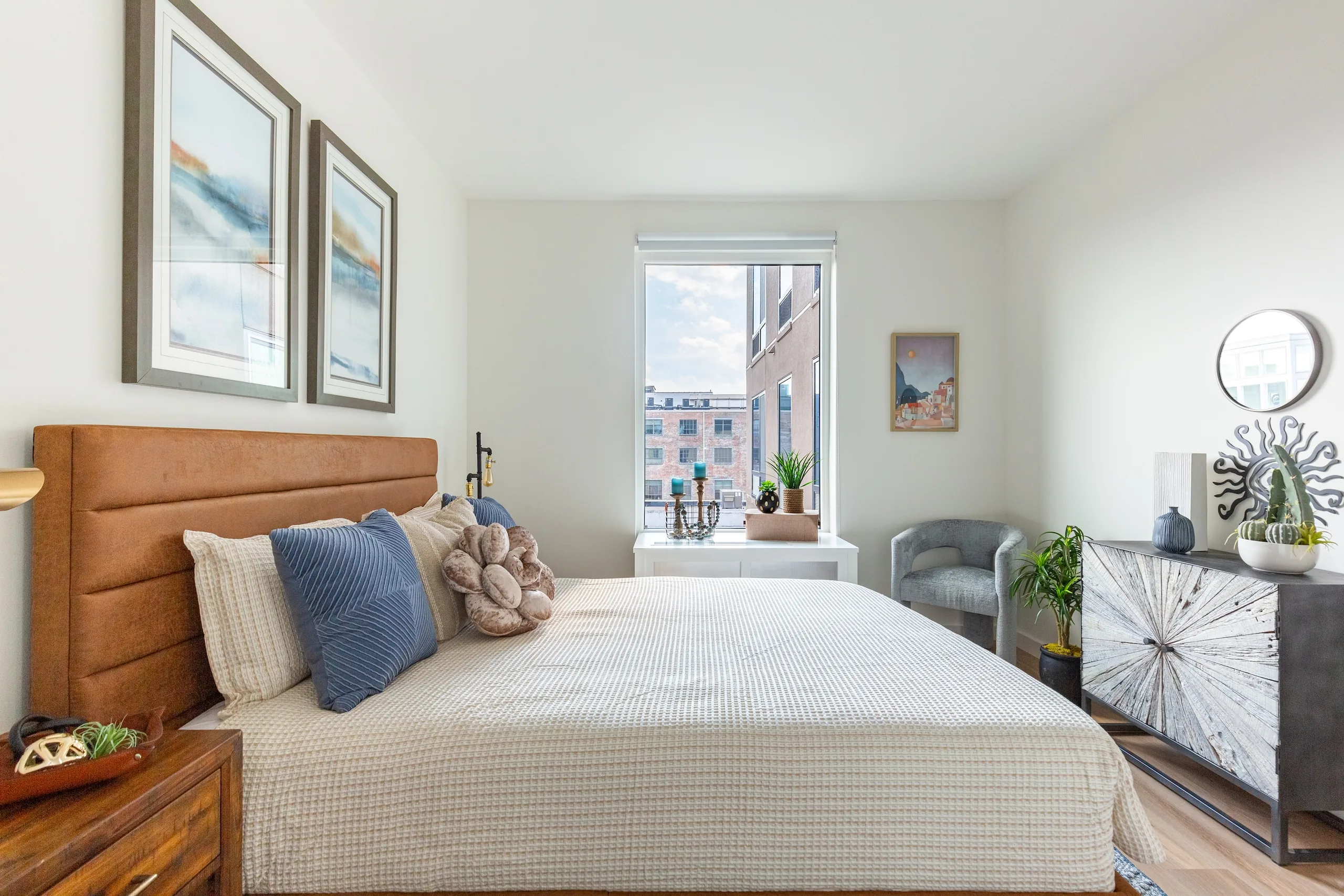 Bedroom with upholstered bed, warm furnishings and natural light