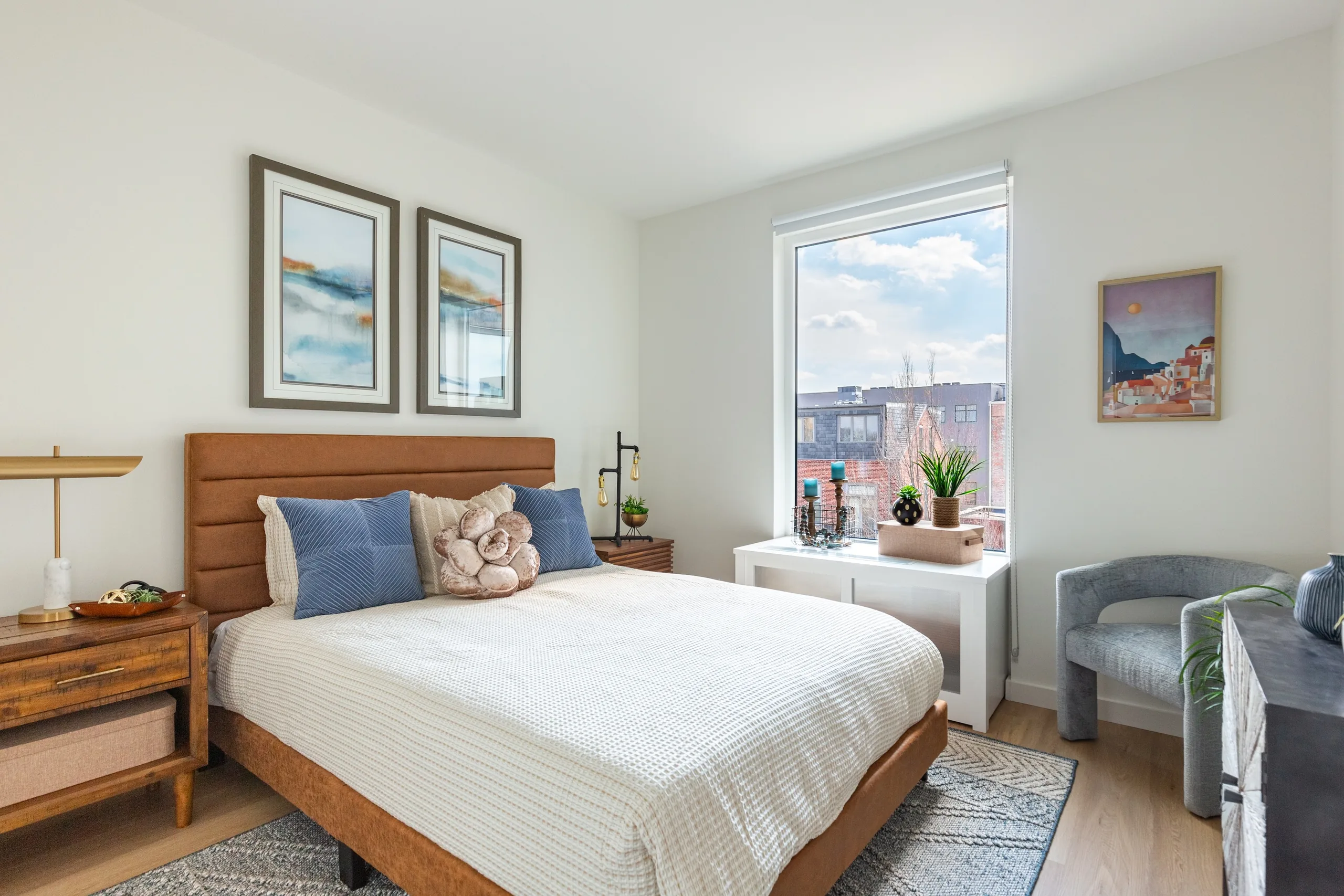 Bedroom with wood-framed bed and a downtown window view