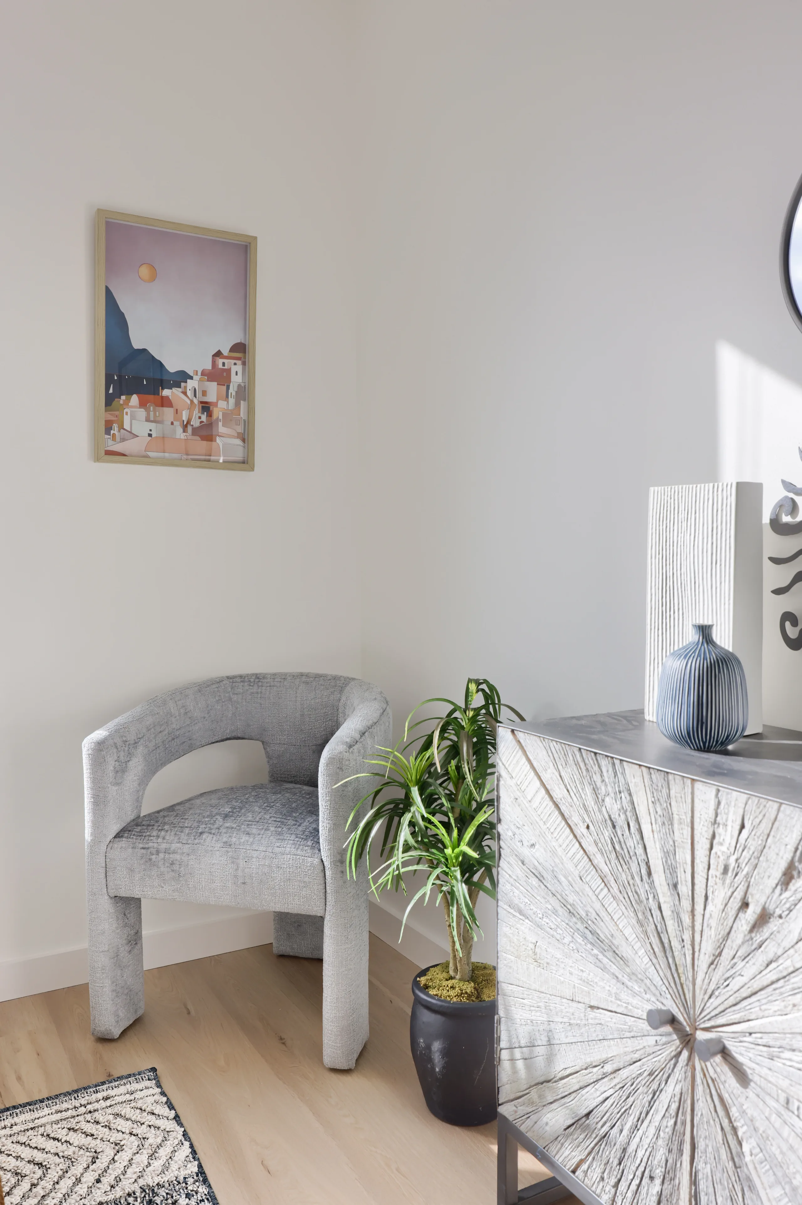 Bedroom seating and dresser detail in natural light