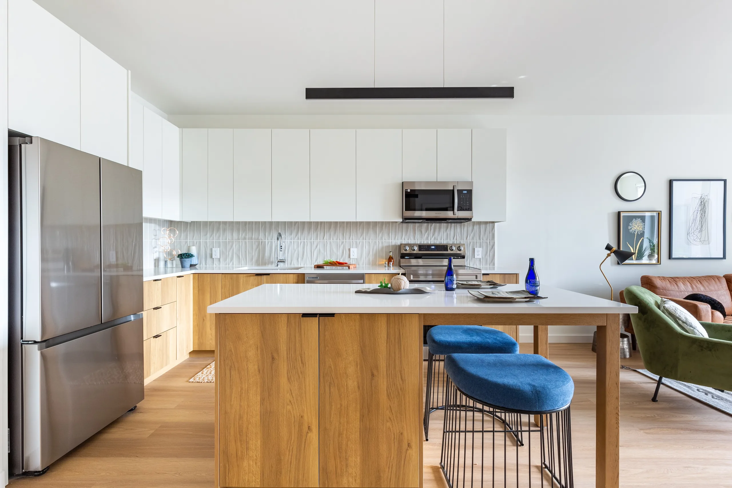 White and oak kitchen cabinetry around a generous island at The Alistair