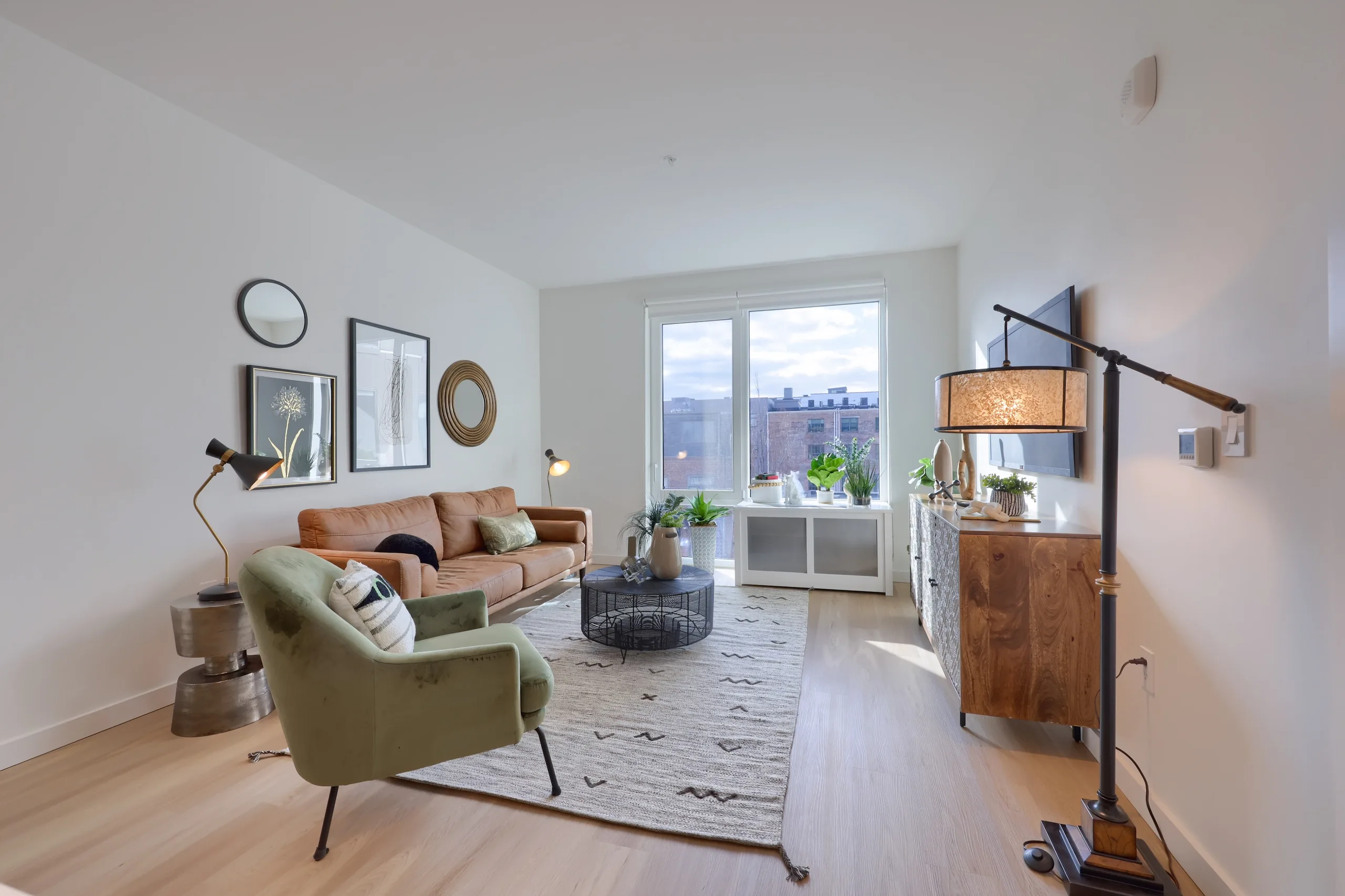 Living room seating and furnishings facing a Lancaster window view