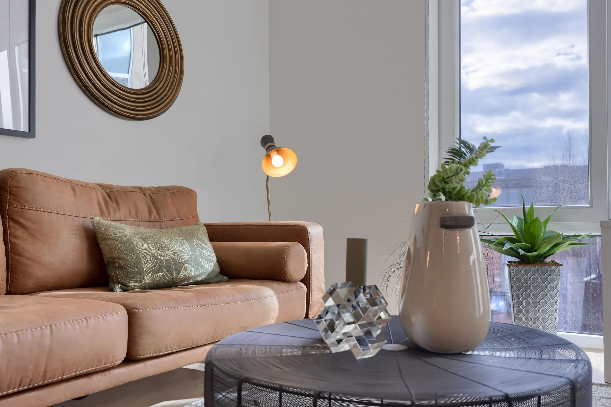 Staged living room beside a large casement window