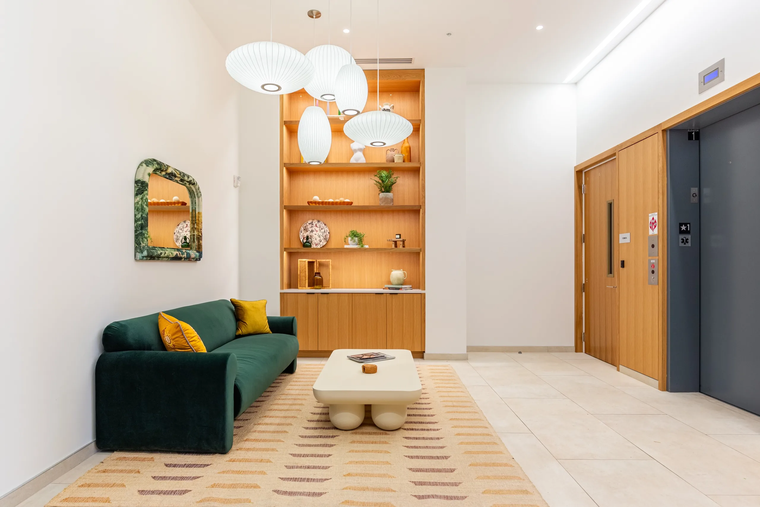 The Alistair lobby with green seating and oak display shelving