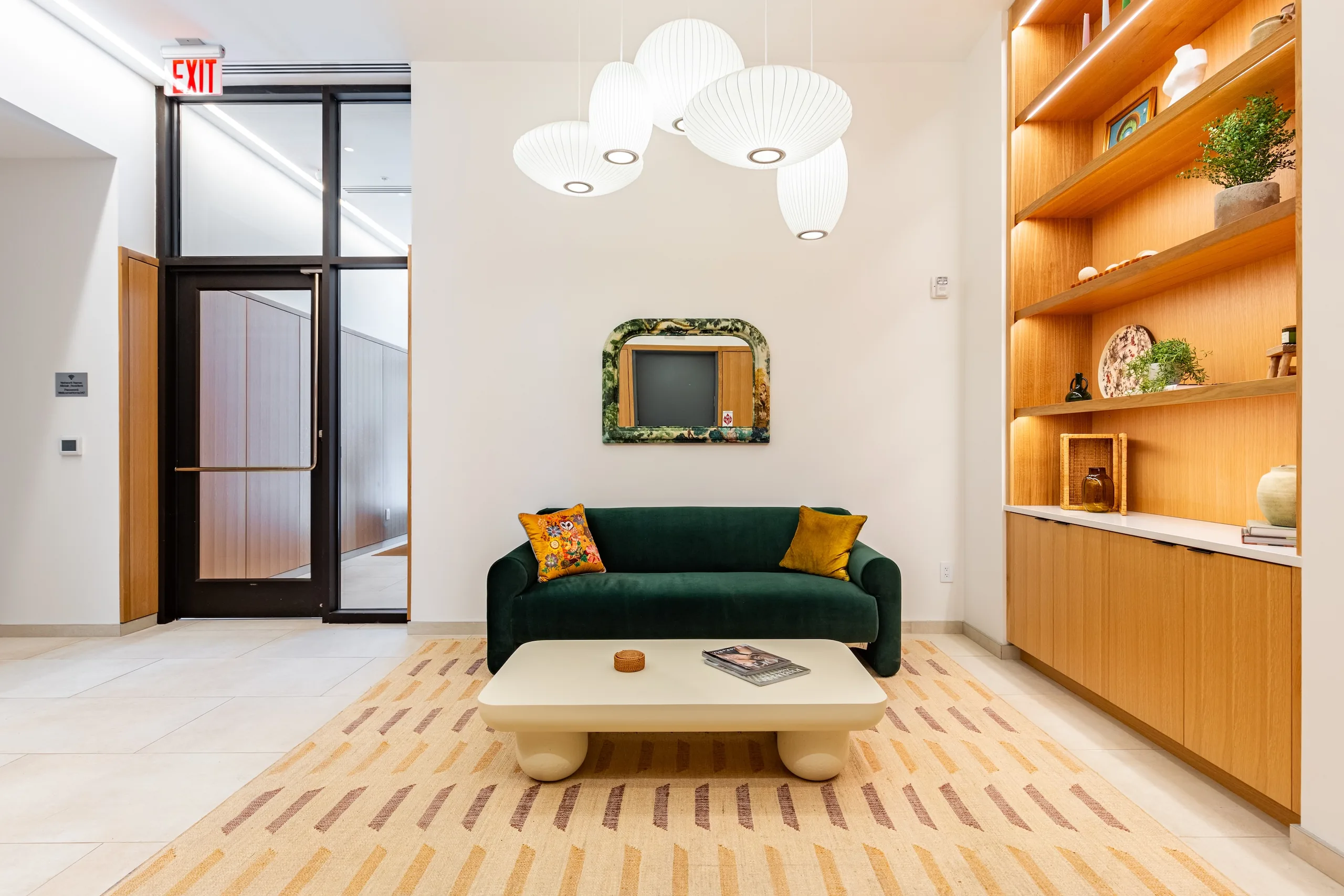 The Alistair lobby with custom white-oak millwork, sculptural lights and lounge furnishings