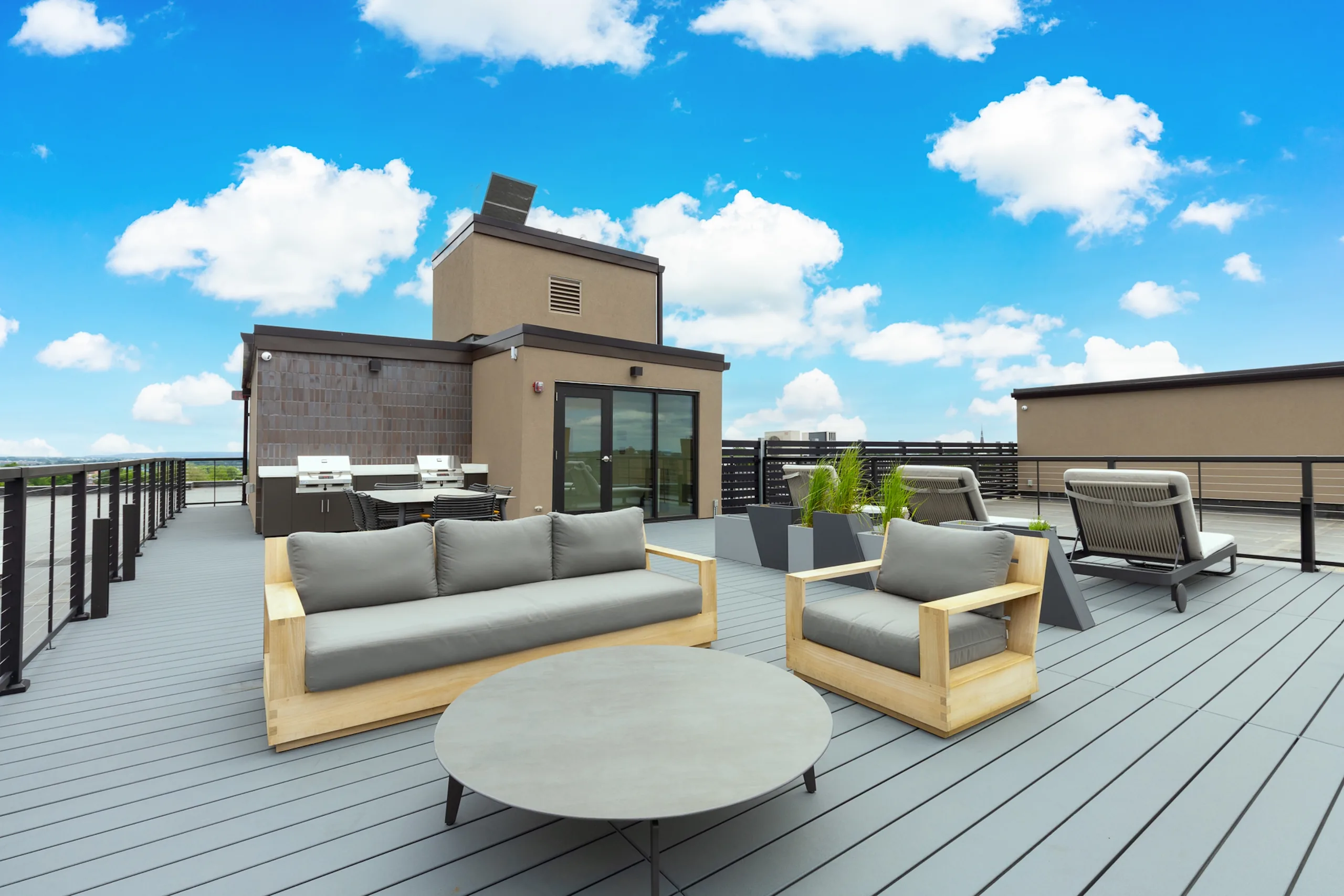 Rooftop lounge seating beneath a blue Lancaster sky
