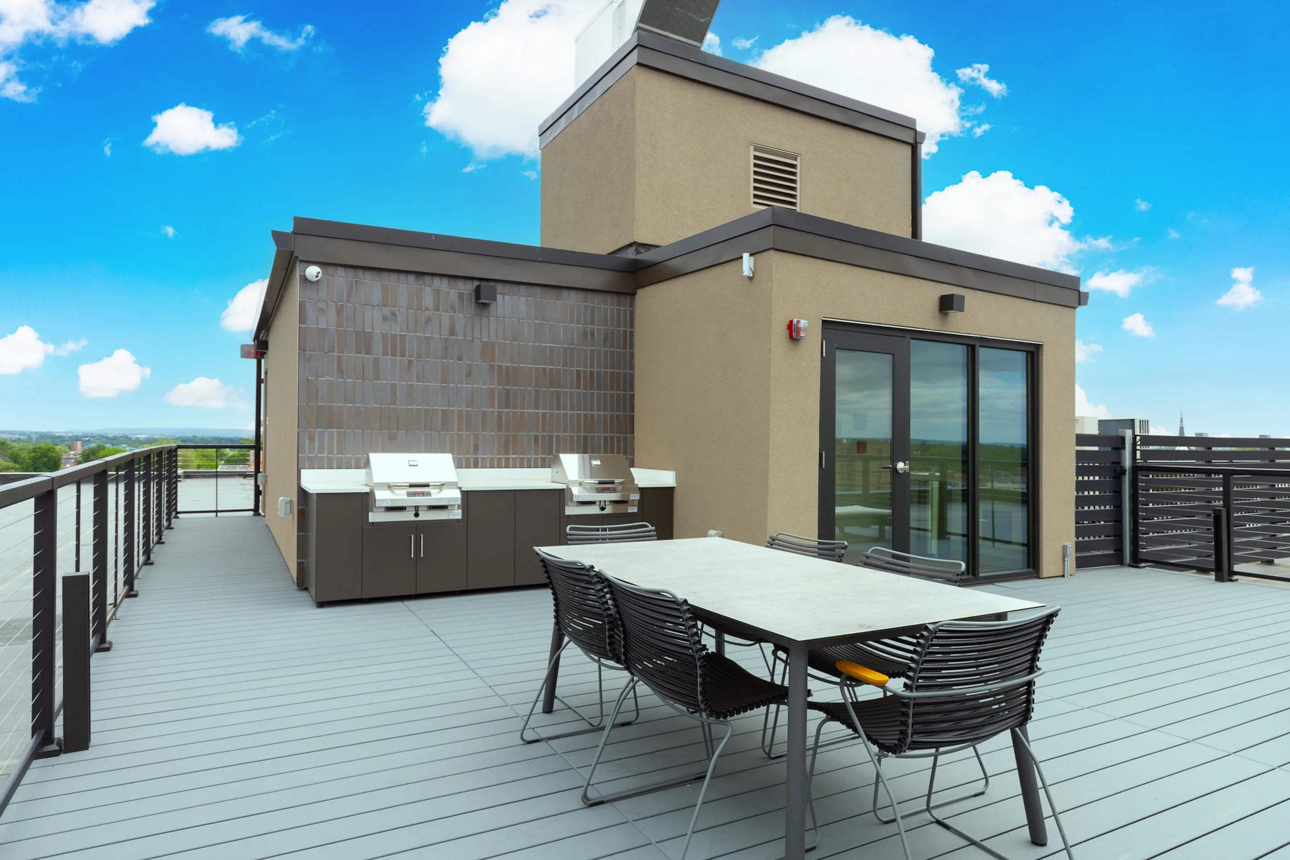 Rooftop dining table and grills overlooking Lancaster