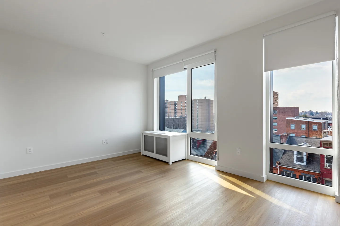 Vacant studio living area at The Alistair with large windows and downtown Lancaster views